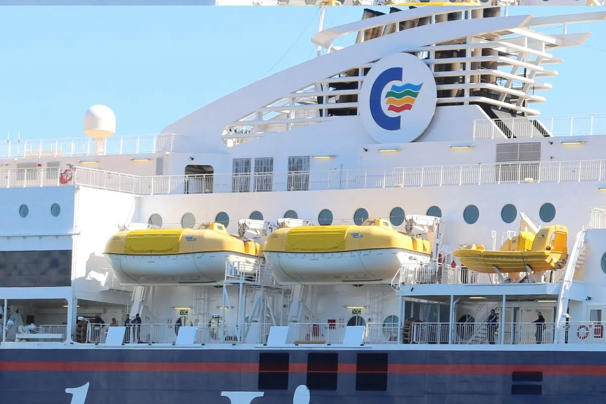 The upper decks and funnel of a Color Line ferry alongside the quay, with lifeboats along the boat deck