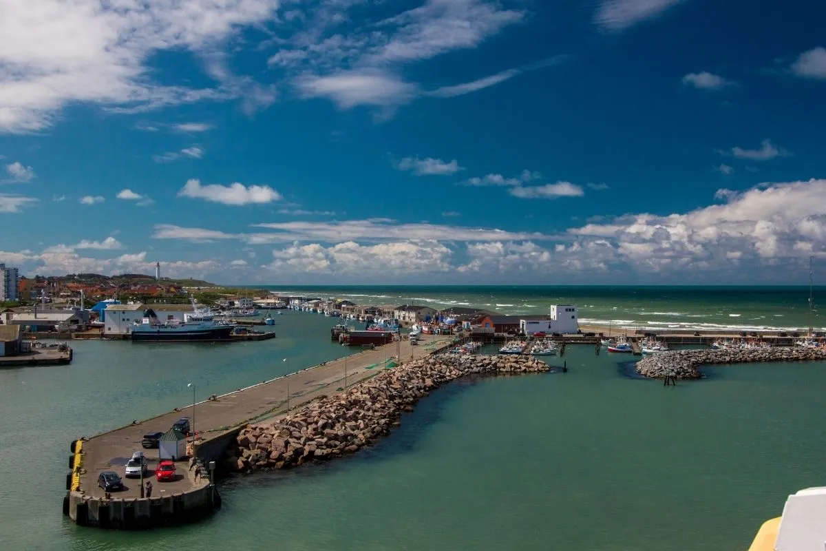 The pier and harbour entrance at Hirtshals seen from a departing ferry, with the North Sea beyond the breakwater